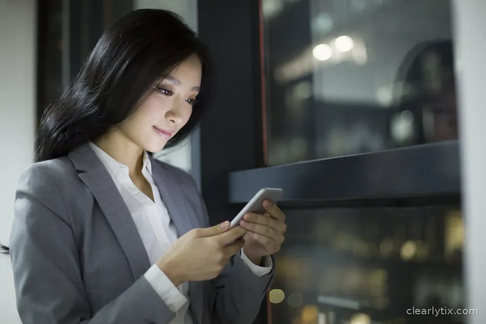 A woman uses her smartphone in an office in the evening.